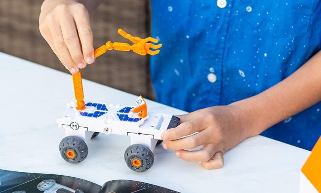 Child building a space rover toy