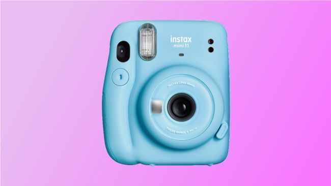 instax mini instant camera on pink background