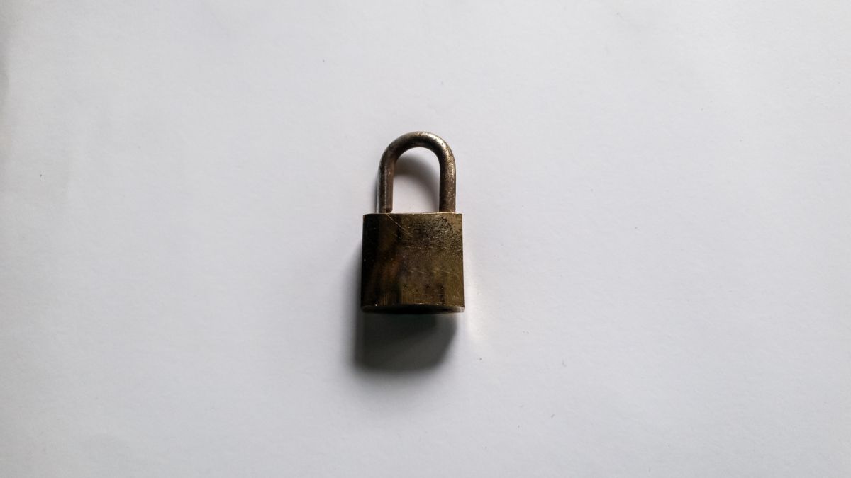 Rusty padlock on a white backdrop