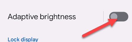 Toggle off "Adaptive Brightness."