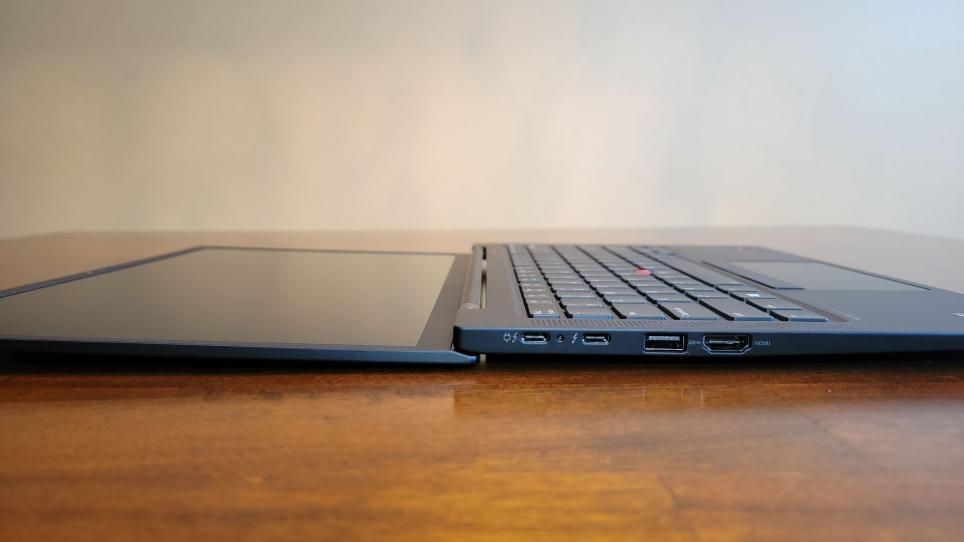 closeup of the available ports on the lenovo thinkpad x1 carbon gen 9 laptop, including two usb-c ports, one usb-a port, and an hdmi port