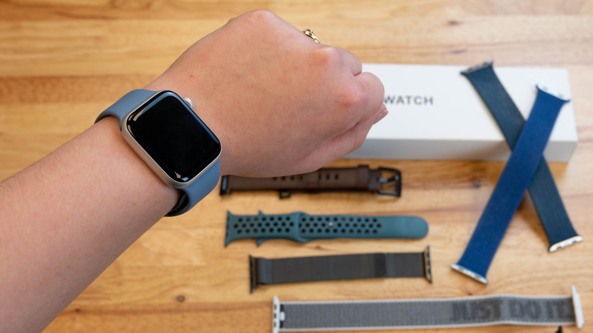 Numerous Apple Watch Bands laying on a table