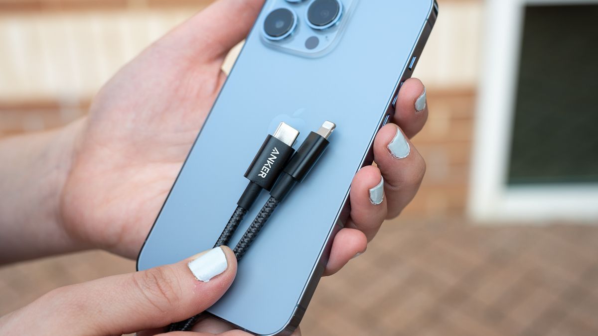 Person holding the Anker New Nylon USB-C to Lighting cable next to an iPhone