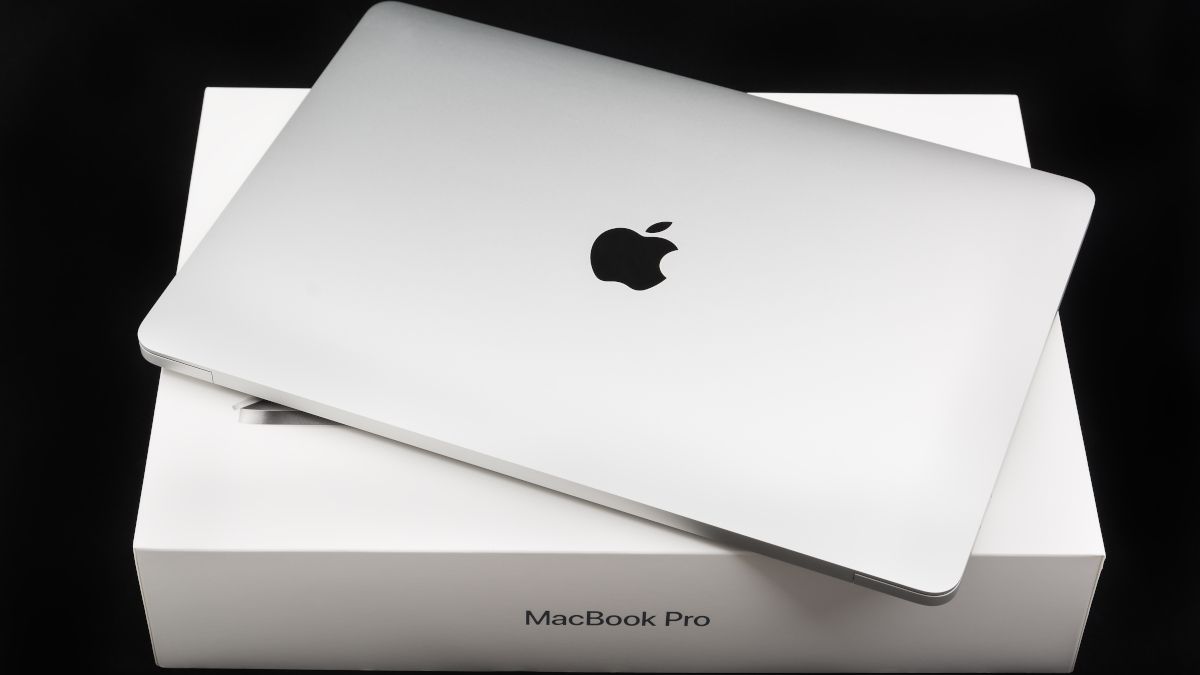 A closed MacBook Pro on top of original packaging