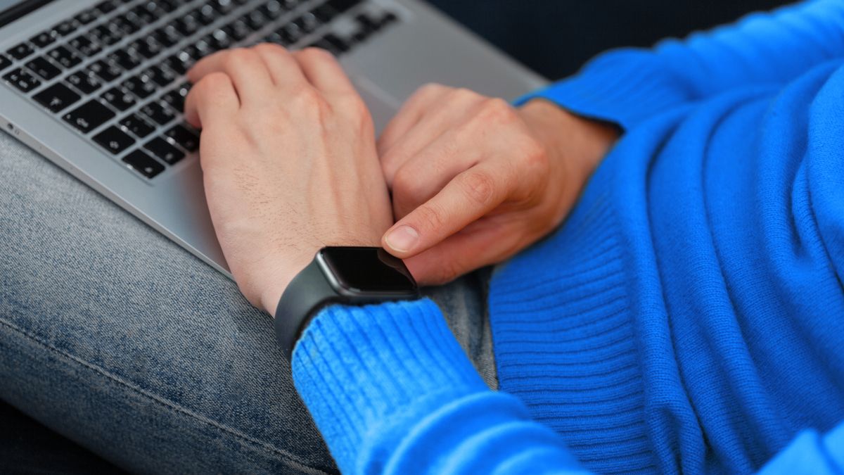 Man's hand touching Apple Watch