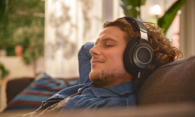 person relaxing with Philips SHP headphones