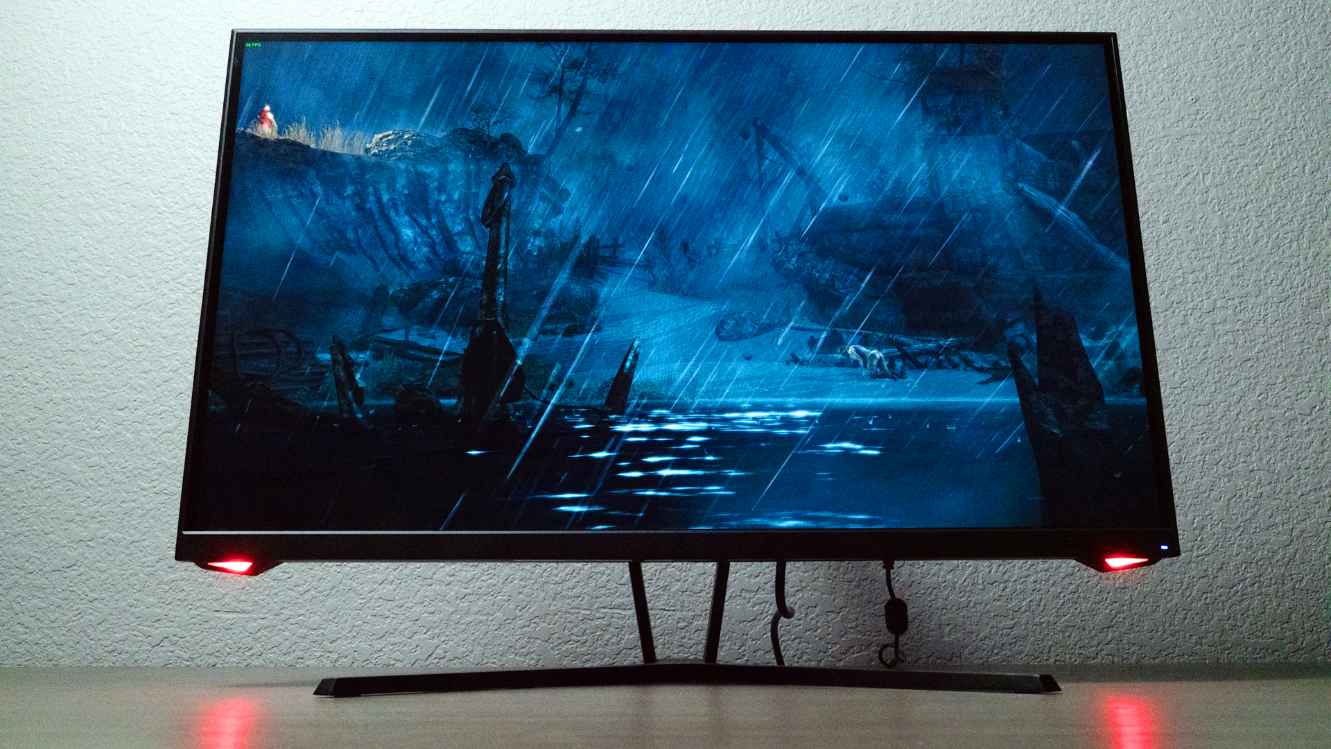 Dark Matter monitor while playing a video game, with the front LED lights reflecting off table