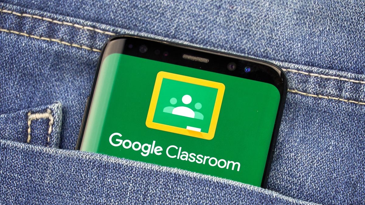 Google Classroom logo shown on a smartphone screen in a jean pocket