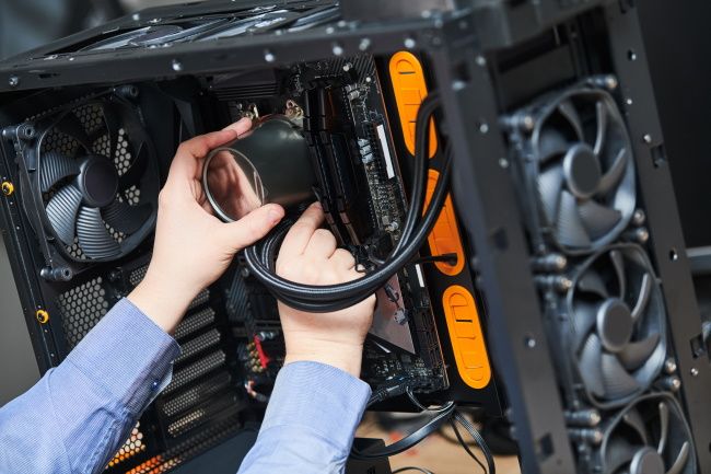 A person installing liquid cooling in a PC.