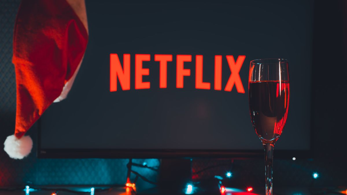 Netflix logo on a TV screen with a Santa hat and champagne flute