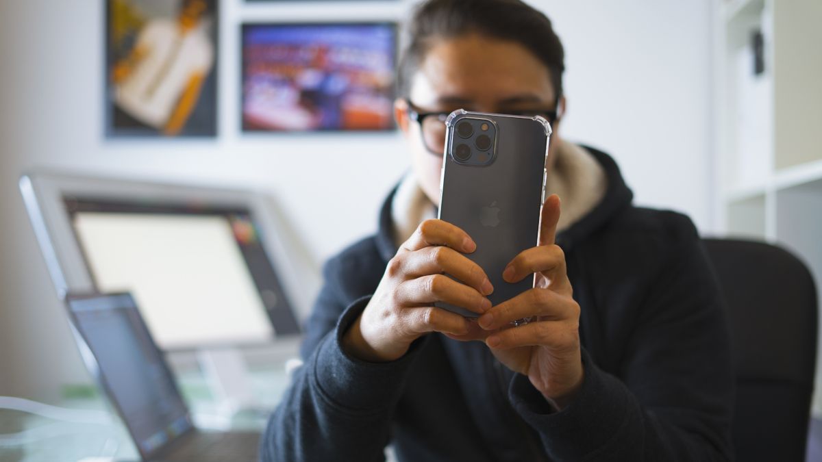 Person holding up an iPhone 12 Pro Max to take a picture