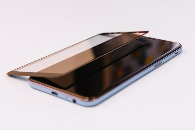 Smartphone with a tempered glass shield detached from it