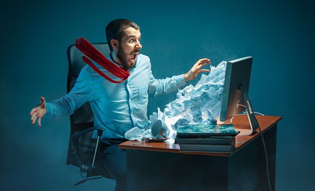 Photo illustration of a man reacting to spam coming from his monitor.