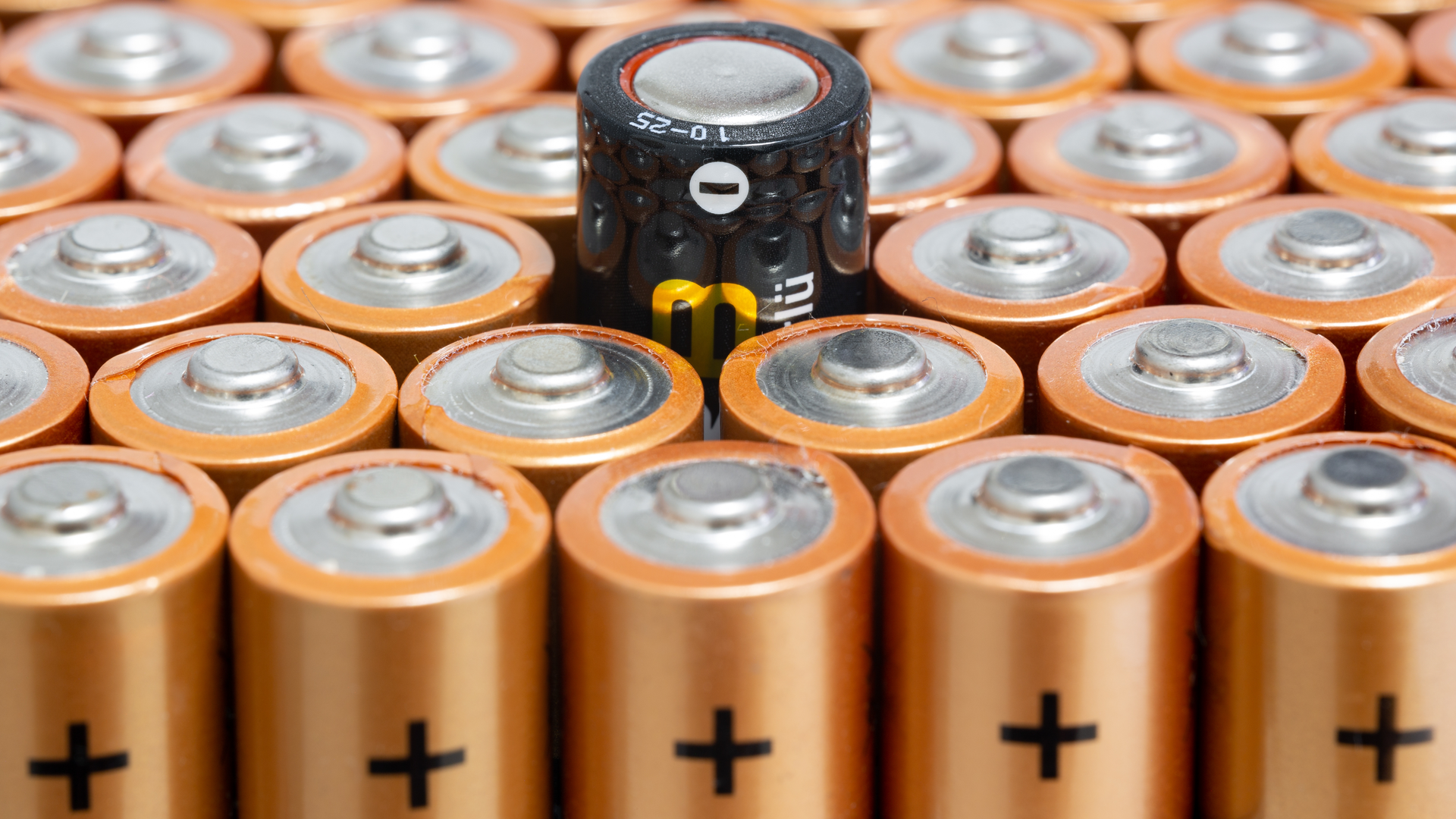 a pile of batteries, with one very different from the others