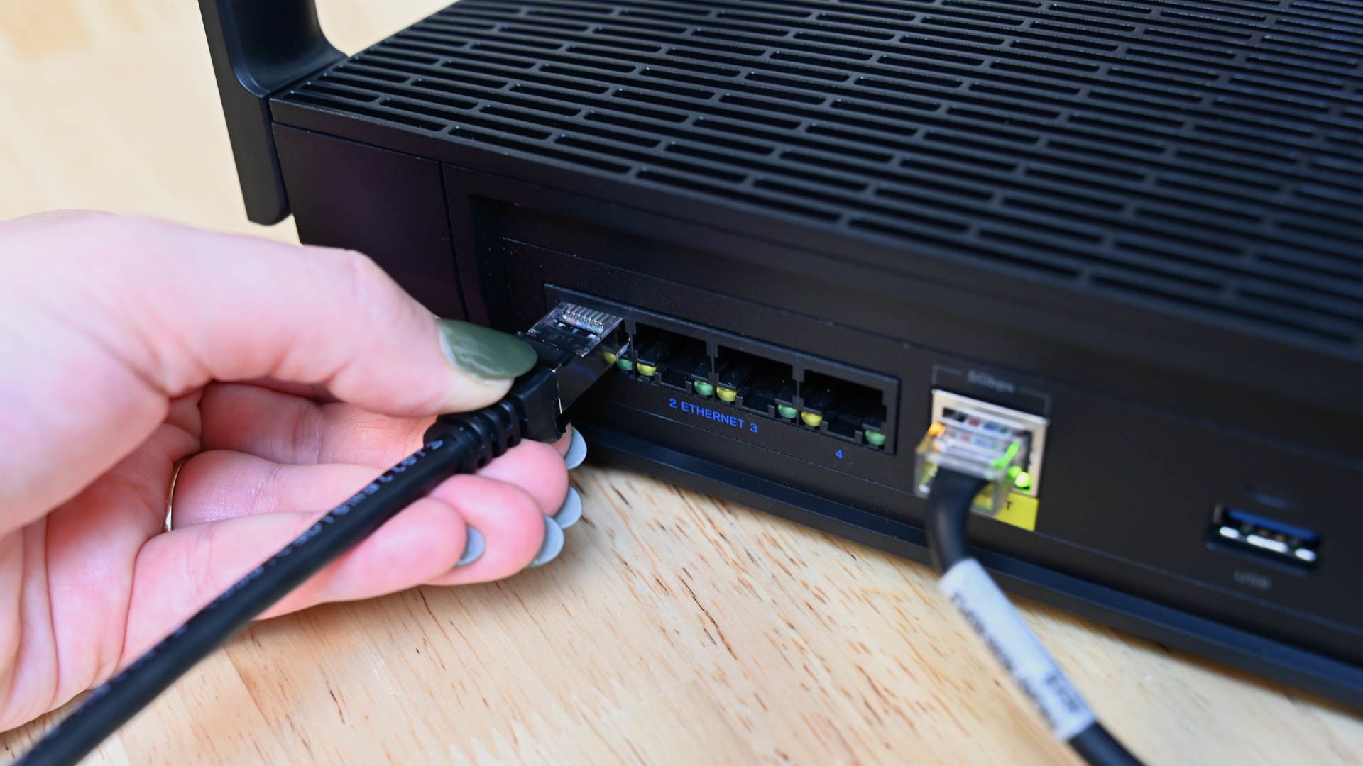 Person plugging in the Cable Matters ethernet cable into a router