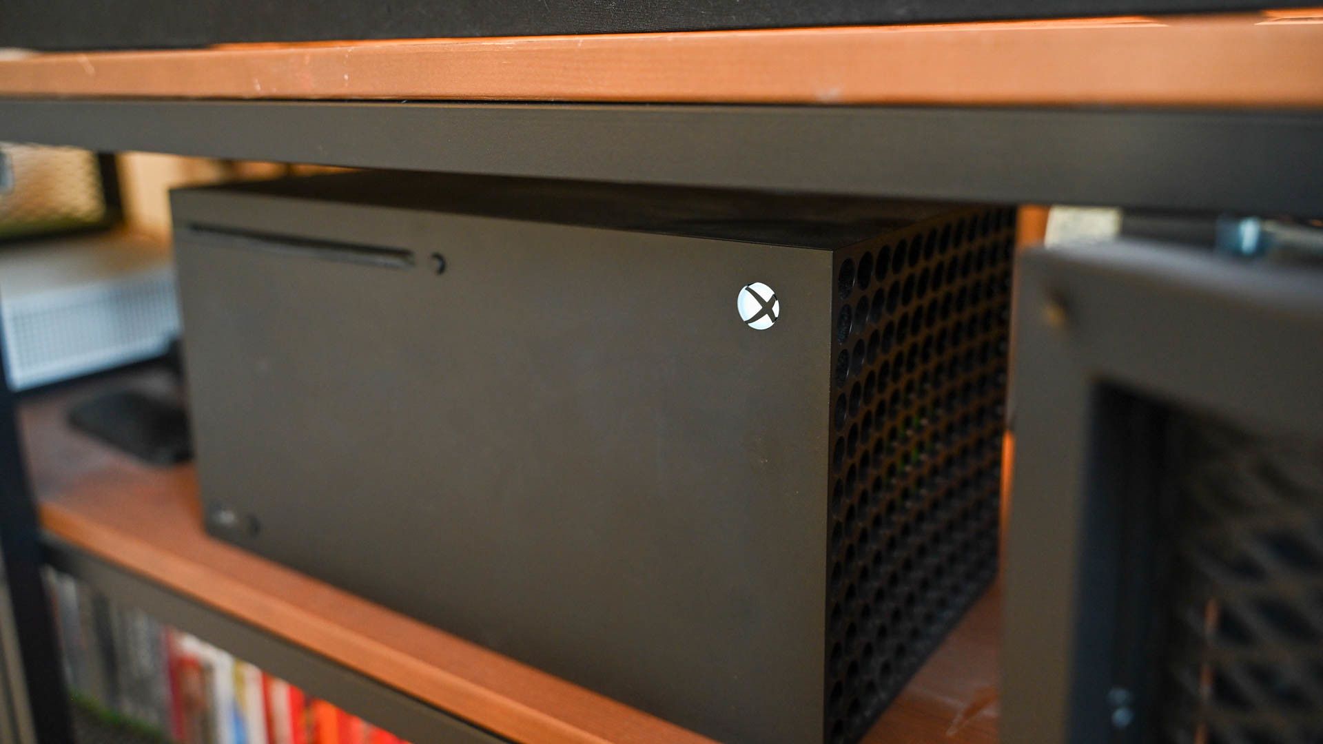 An Xbox Series X console on a shelf.