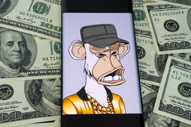 Bored Ape #9055 displayed on a smartphone on a pile of cash.