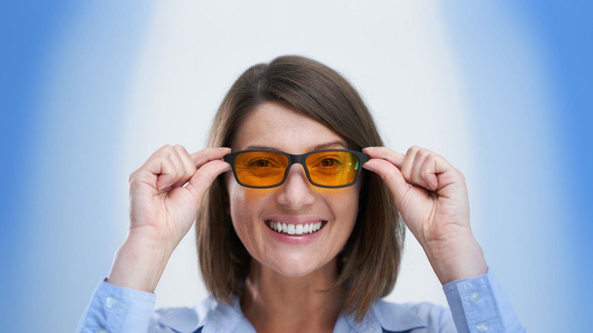 A woman wearing blue light-blocking glasses.