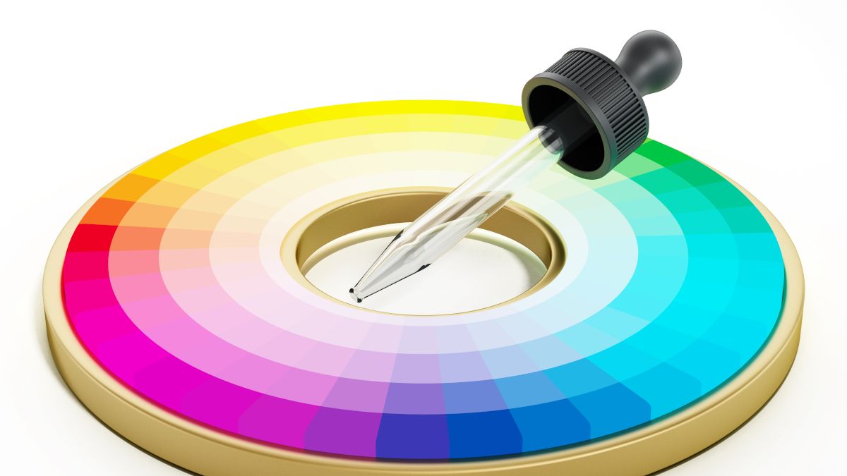 An eyedropper in the middle of a color wheel.