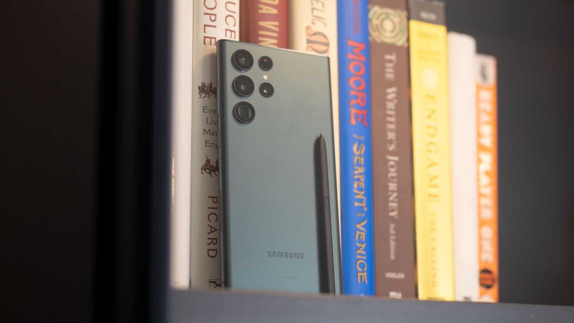 Samsung Galaxy S22 Ultra propped up in a bookcase