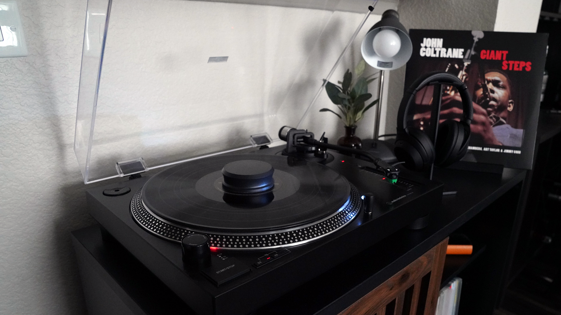 My simple, sweet turntable setup, with a pair of headphones and album on display next to it