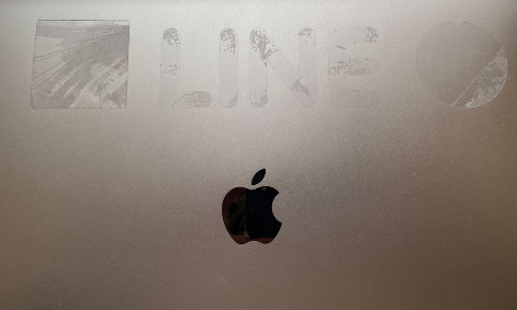A laptop with adhesive on the case.