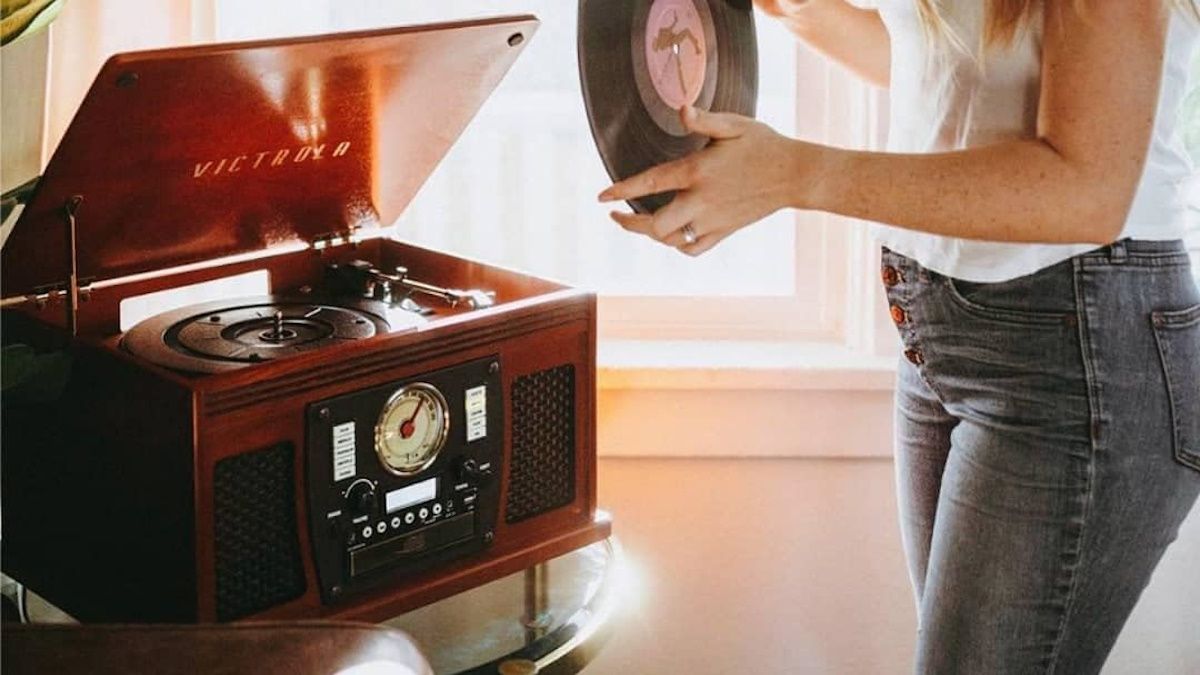 Person using Victrola record player