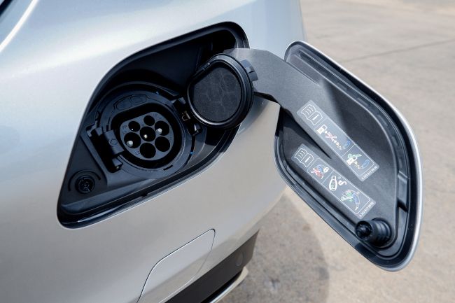 Closeup of a standard J1772 charging socket on an electric vehicle.