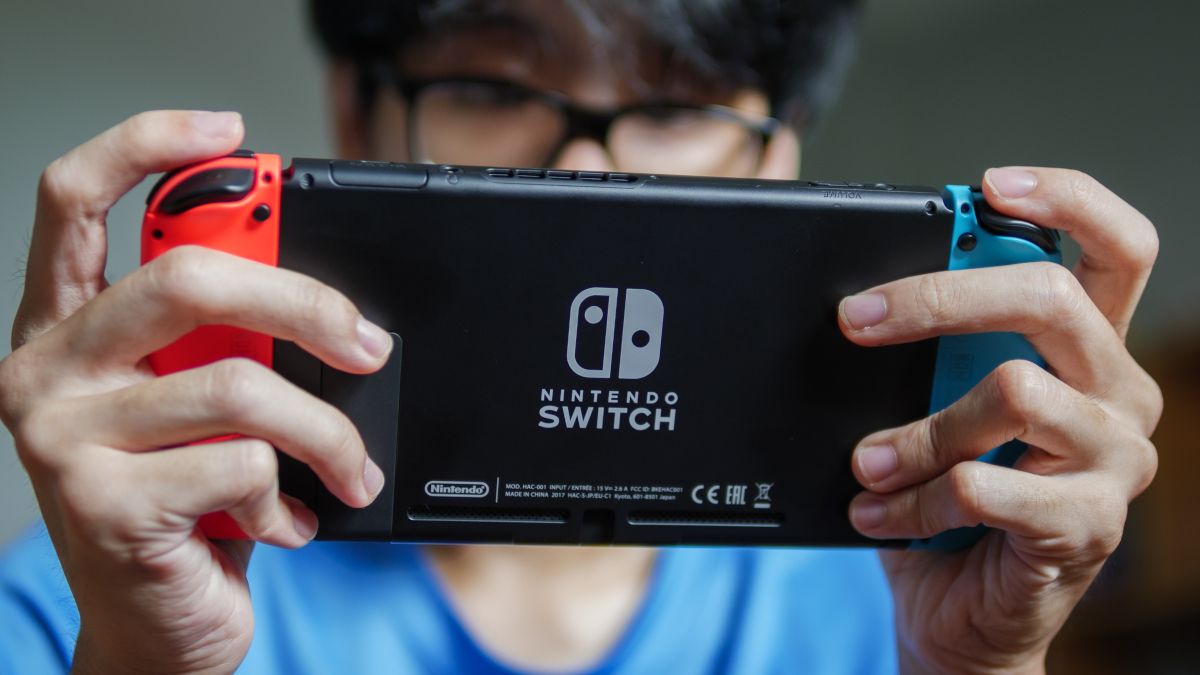 A man playing a Nintendo Switch.