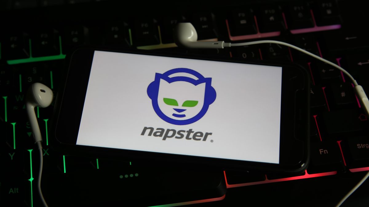 Smartphone showing the Napster logo and surrounded by attached earbuds.