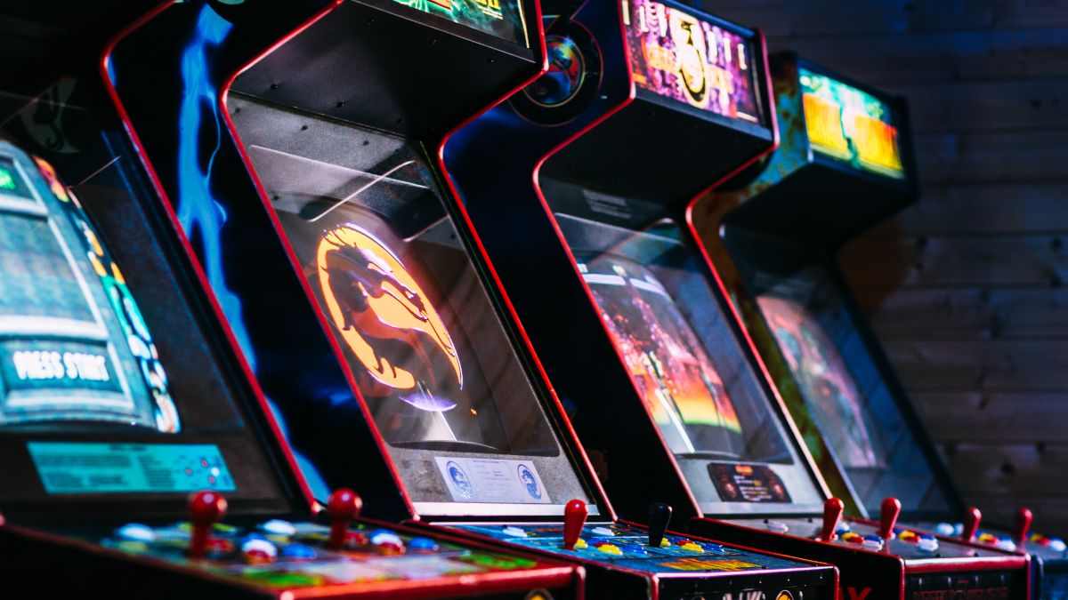 A collection of vintage arcade games in a dark room.