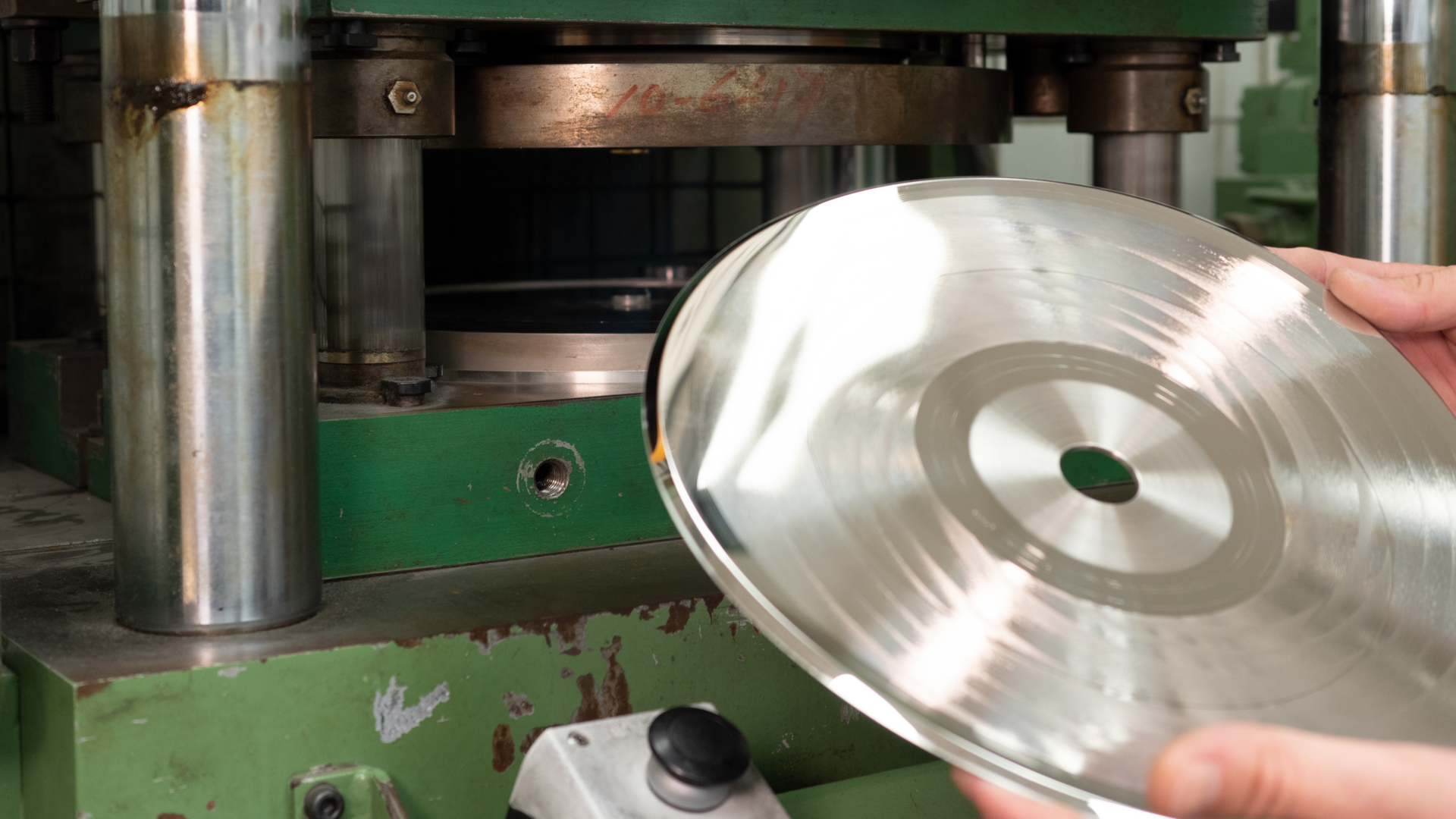 Vinyl record pressing machine in action, Making metal stamper for the press in a vinyl factory