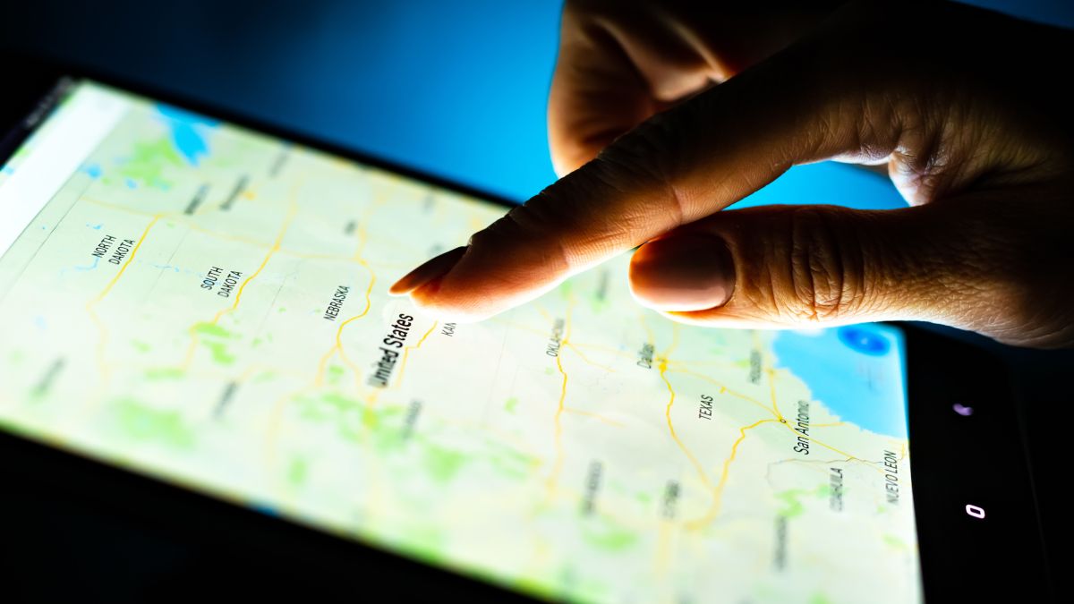 Closeup of a person's finger touching a map on a tablet display.