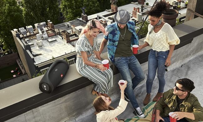 People on rooftop with JBL boombox