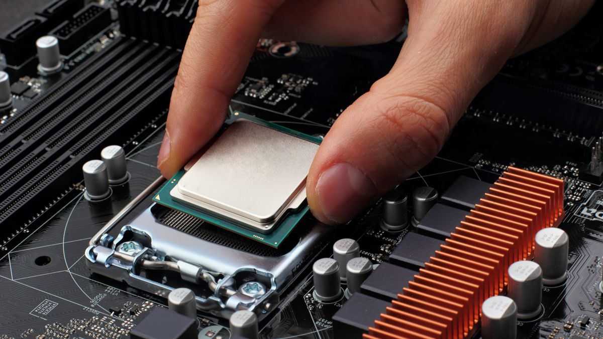 Person installing a CPU on a motherboard.