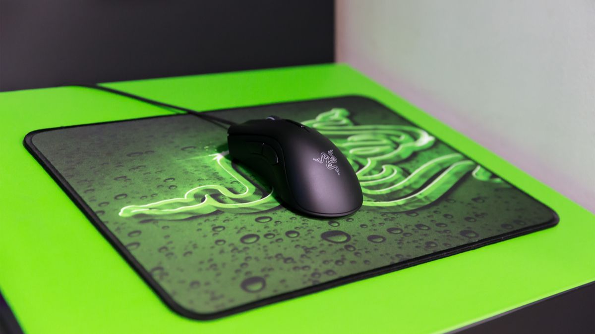 Razer gaming mouse on a mouse pad featuring the Razer logo.