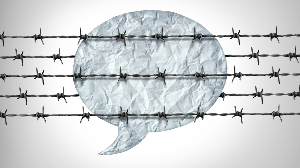 A speech bubble behind barbed wire.
