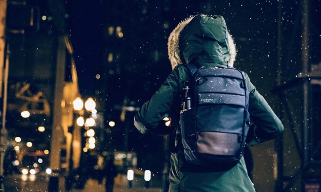 Person using Timbuk2 backpack in the snow