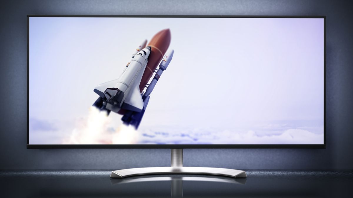 An ultrawide computer monitor with a space shuttle launch on display.