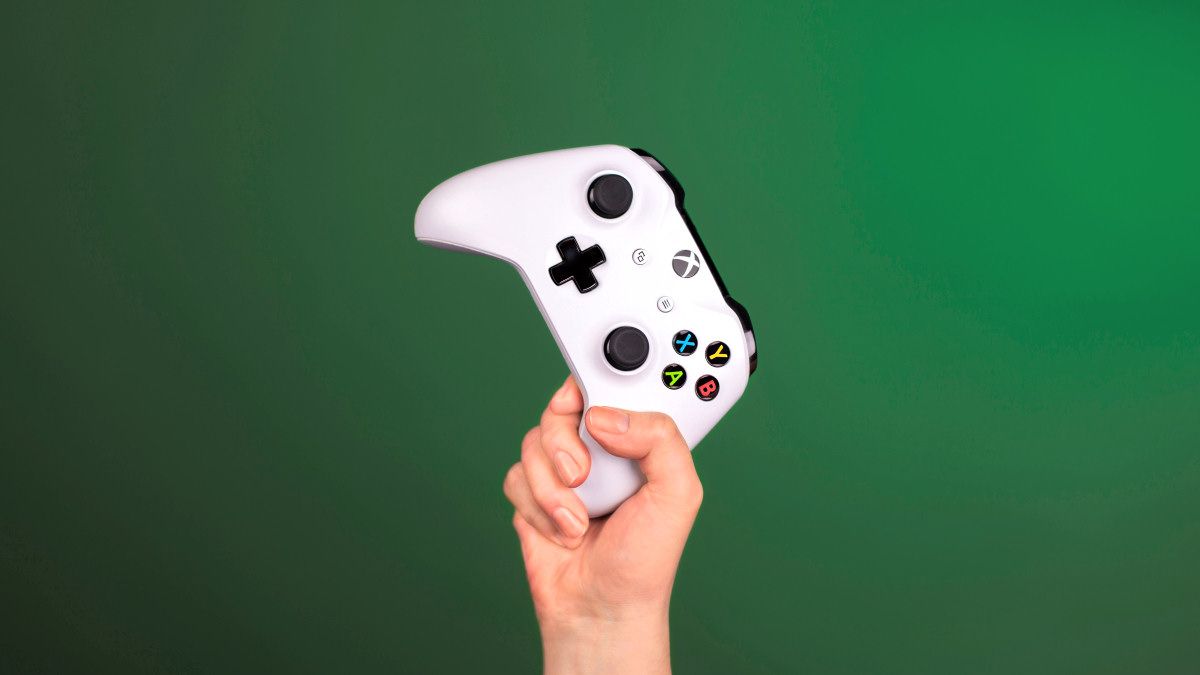 A person's hand holding an Xbox One controller.