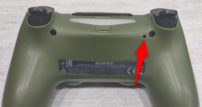 The reset hole on the PS4 controller.