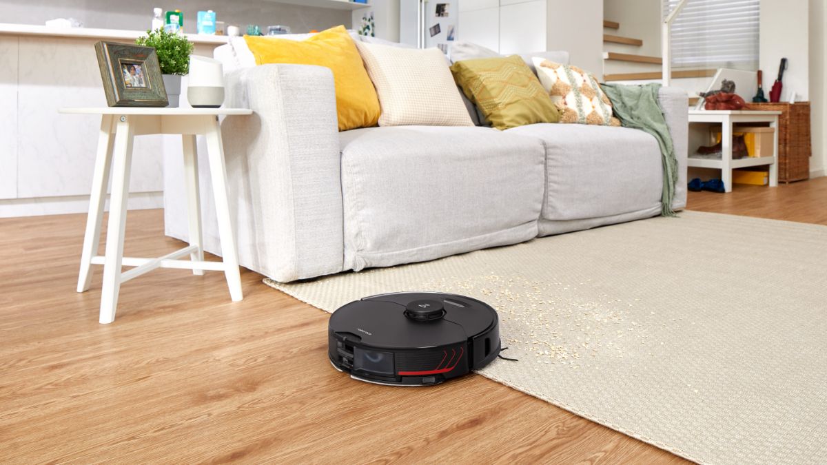 Roborock S7 MaxV Ultra driving over hardwood flooring and a rug