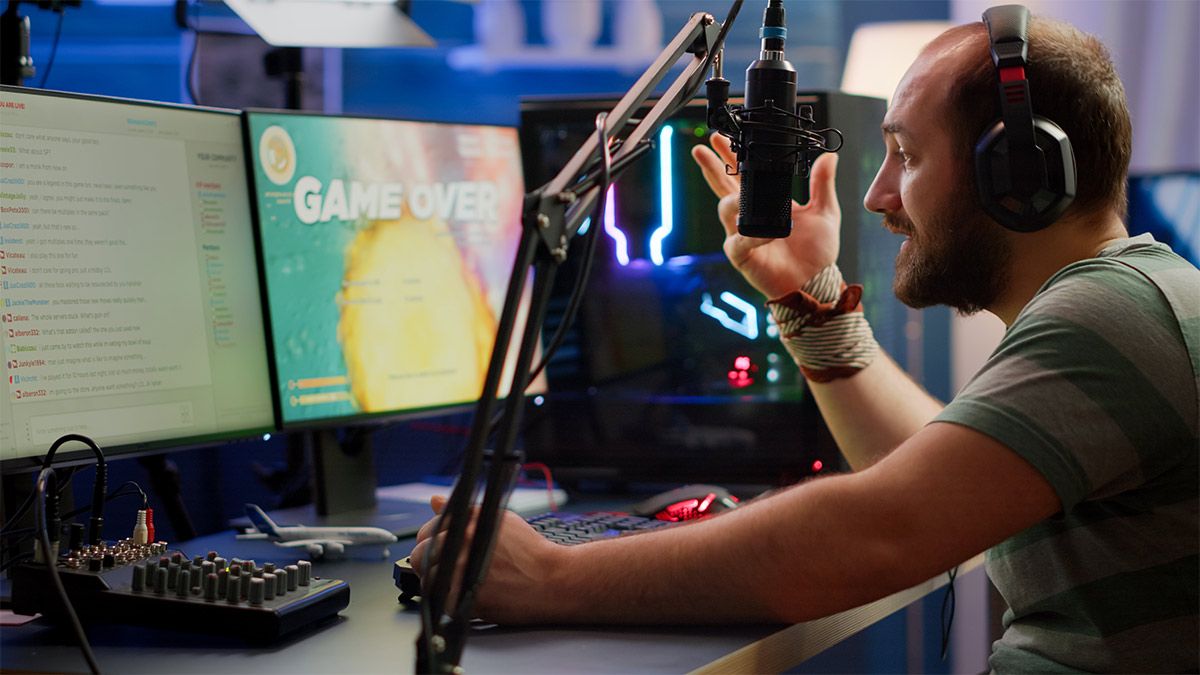A video game streamer at a desk with streaming gear.