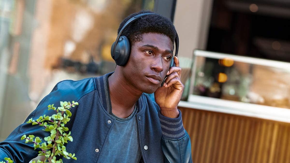 Person wearing Bose 700s outside