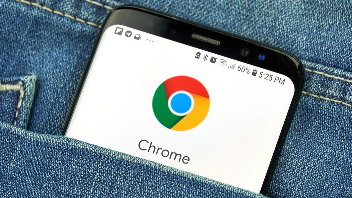 The Chrome app logo on an Android phone tucked in a person's denim pocket.