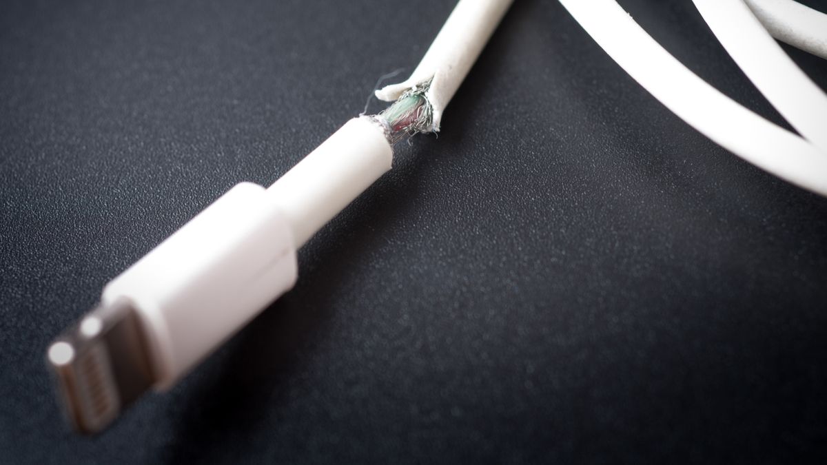 Closeup of a damaged smartphone charging cable.