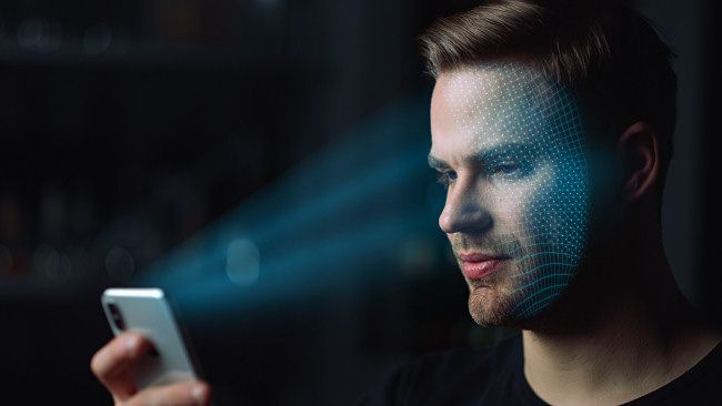 A person scanning their face with Face ID
