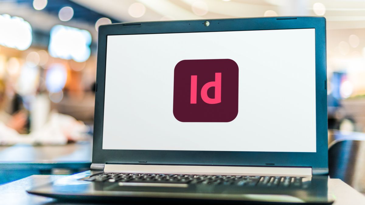 Laptop screen featuring the Adobe InDesign app icon.