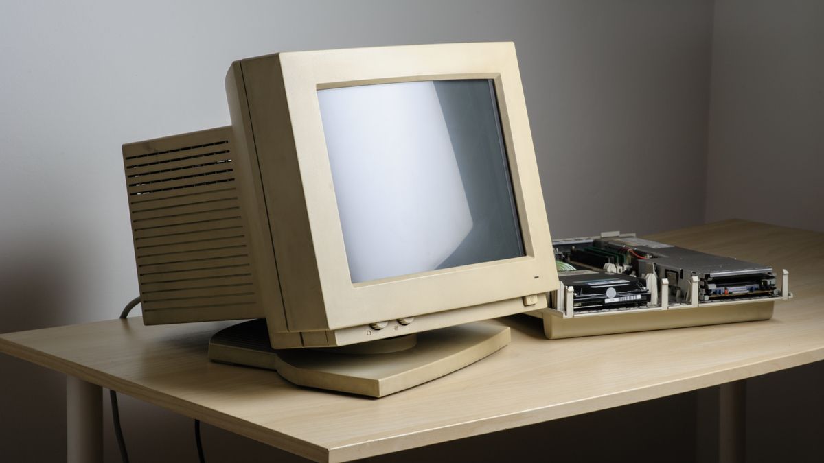 An old and dusty CRT computer monitor on a desk.