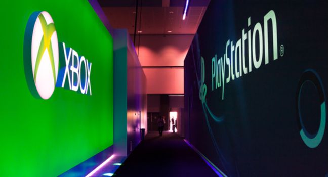 Hallway at a gaming conference with Xbox logo on one side and PlayStation logo on the other.